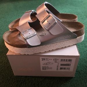 Birkenstock Arizona silver platform sandals.